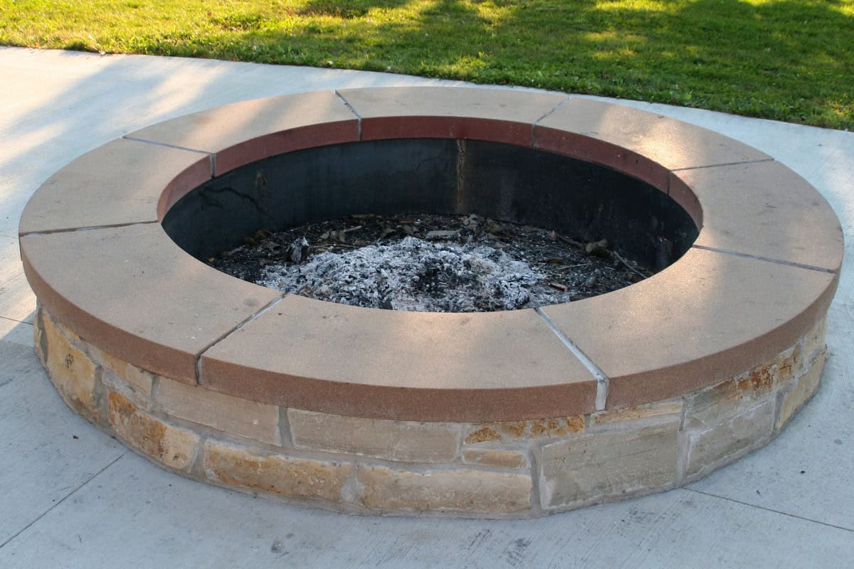 Image of a masonry fire pit that has been extinguished.