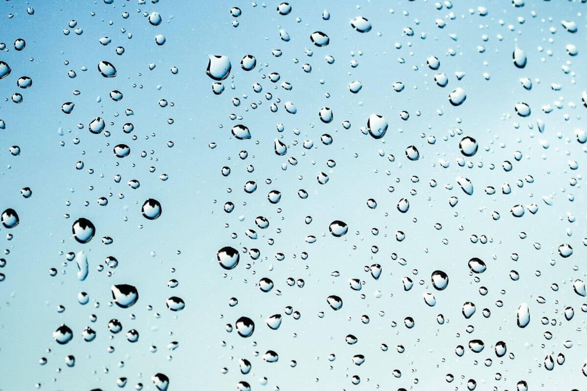 Image of water droplets on a pane of glass.