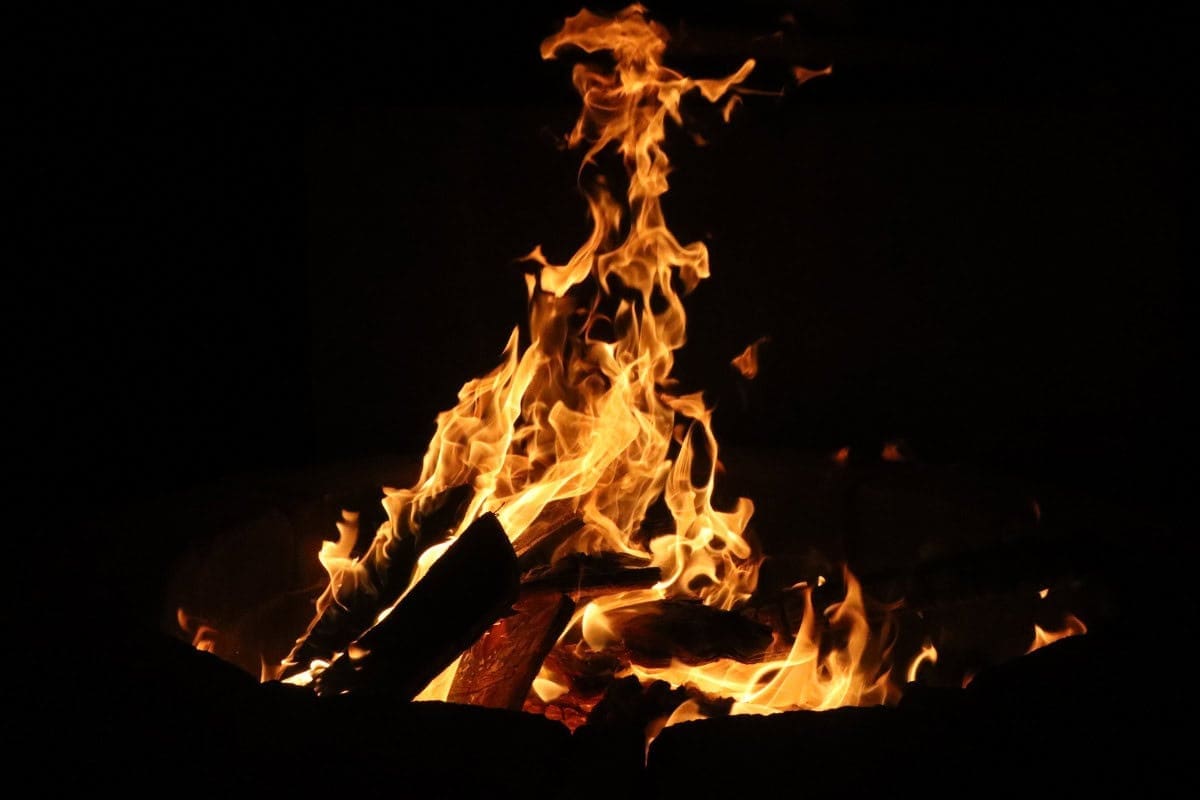 Image of a fire pit burning at night.