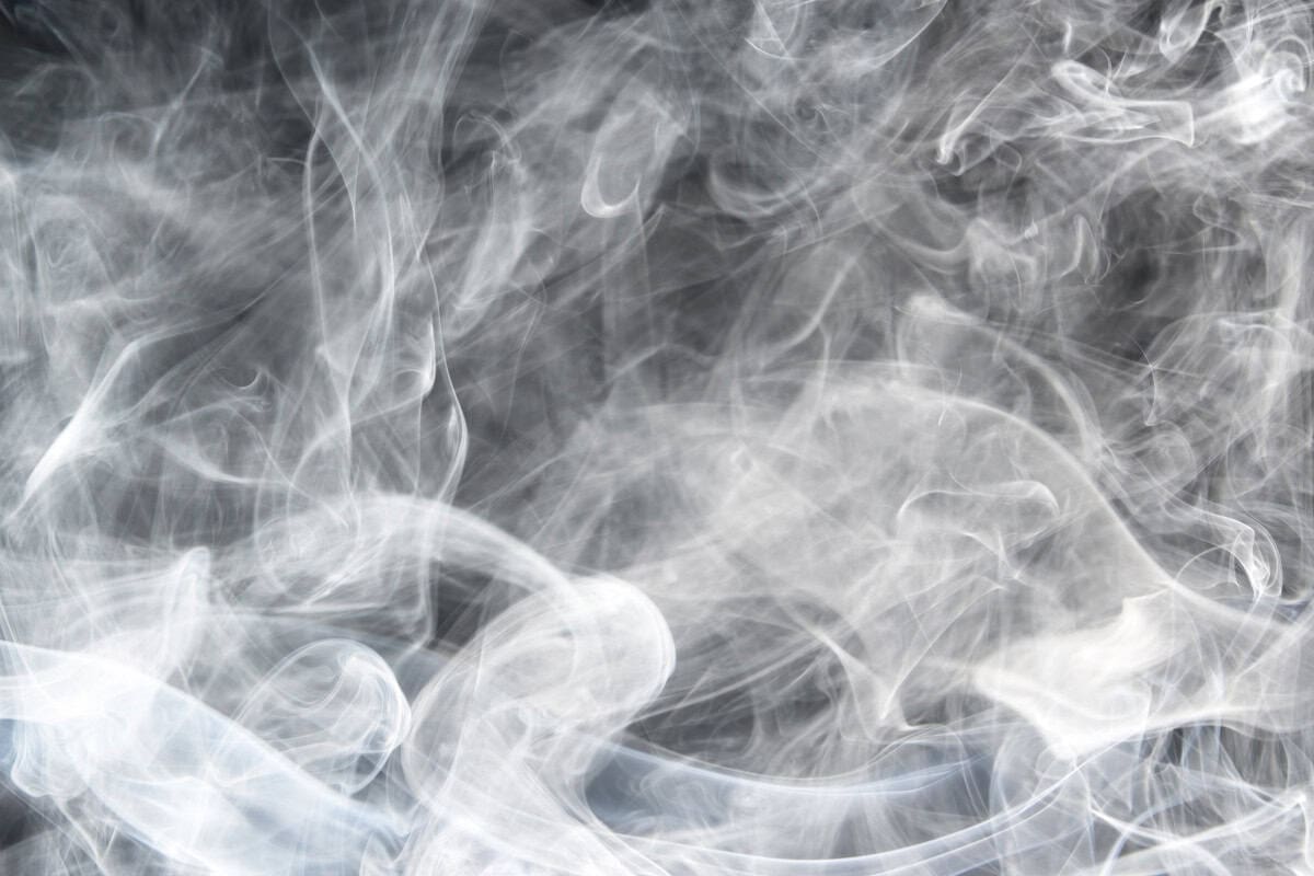 Image of white smoke with a black background.