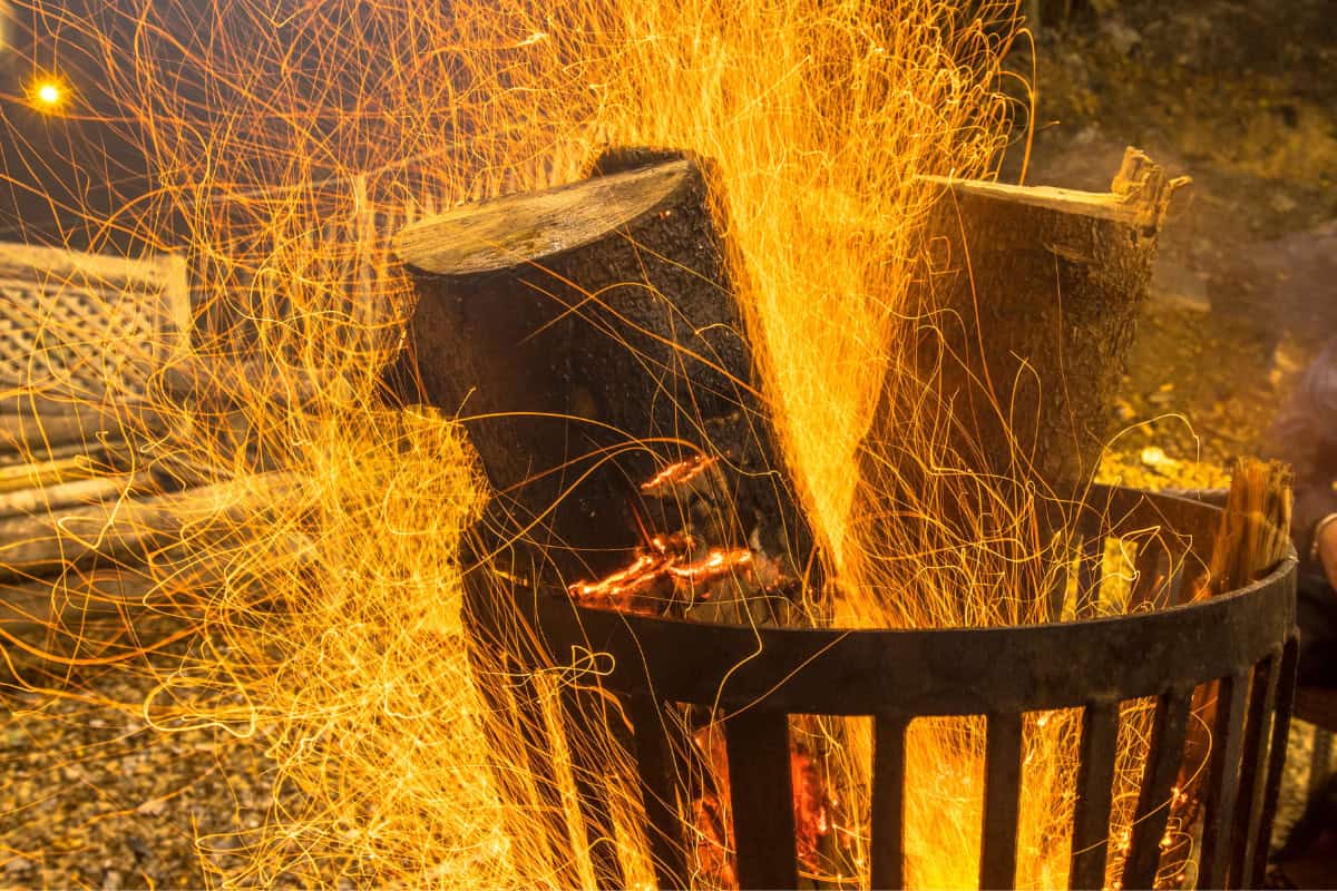 Image of a fire pit burning with sparks.
