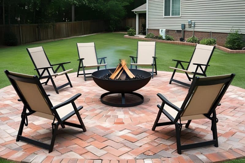 Image of a wood burning fire pit on a brick patio for a blog post about fire pit placement.