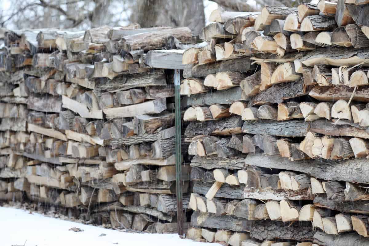 how-to-stack-firewood-closing Image of criss-cross-stacks of wood.