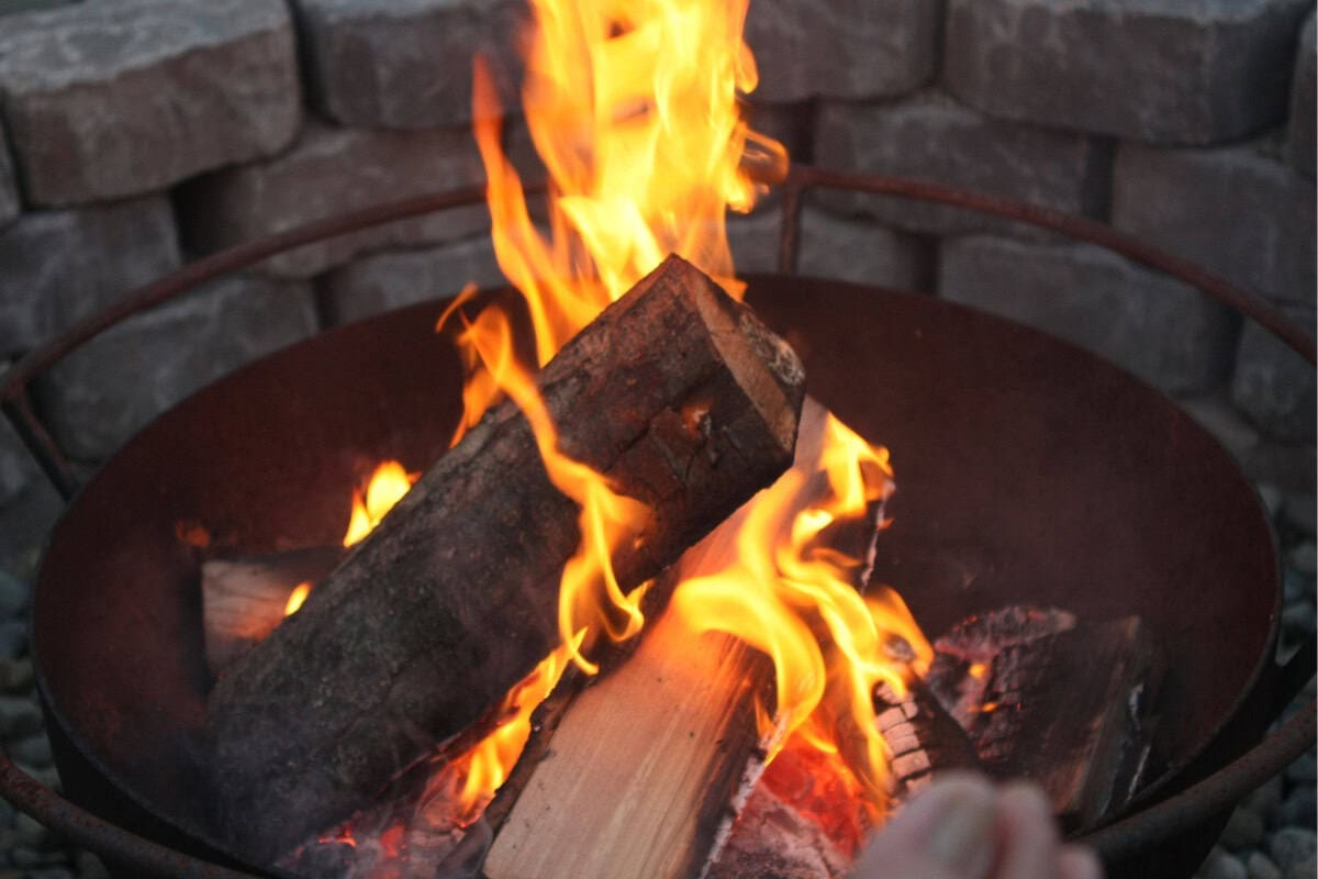 Image of a fire pit burning as the sun goes down.