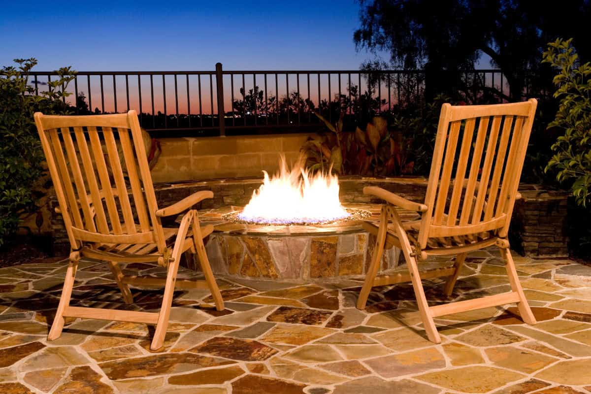 Image of a burning gas fire pit at dusk.