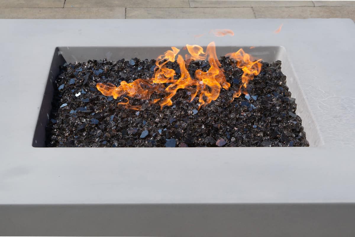 Image of a square gas fire pit with shiny black fire glass.