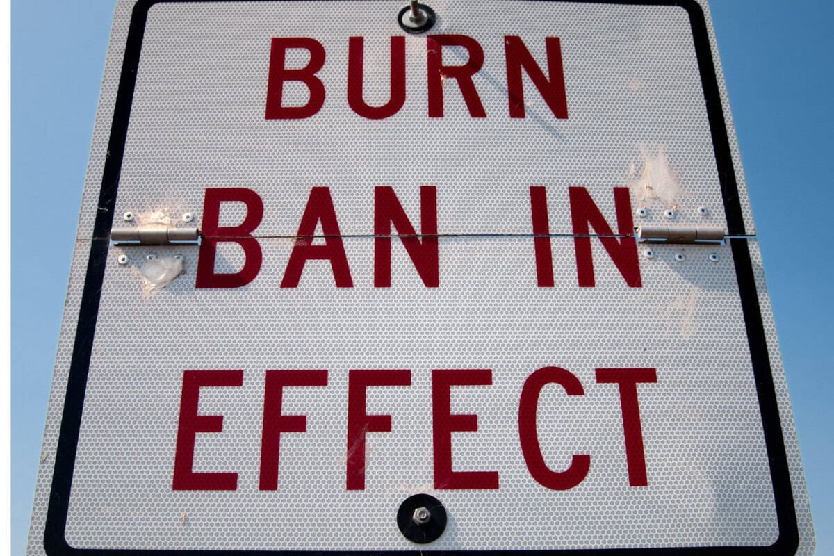 Municipal burn-ban signage Image of a public sign announcing a city burn ban for a blog post covering fire pit fuels.