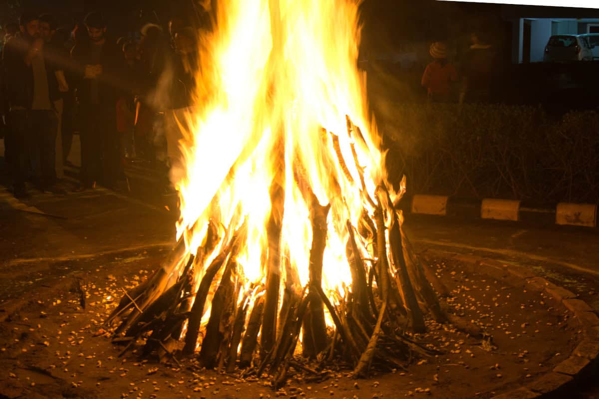 Image of a raging fire pit at night for a post on fire pit history.